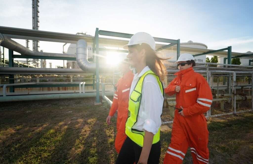 oil and gas workers discussing chemical management systems