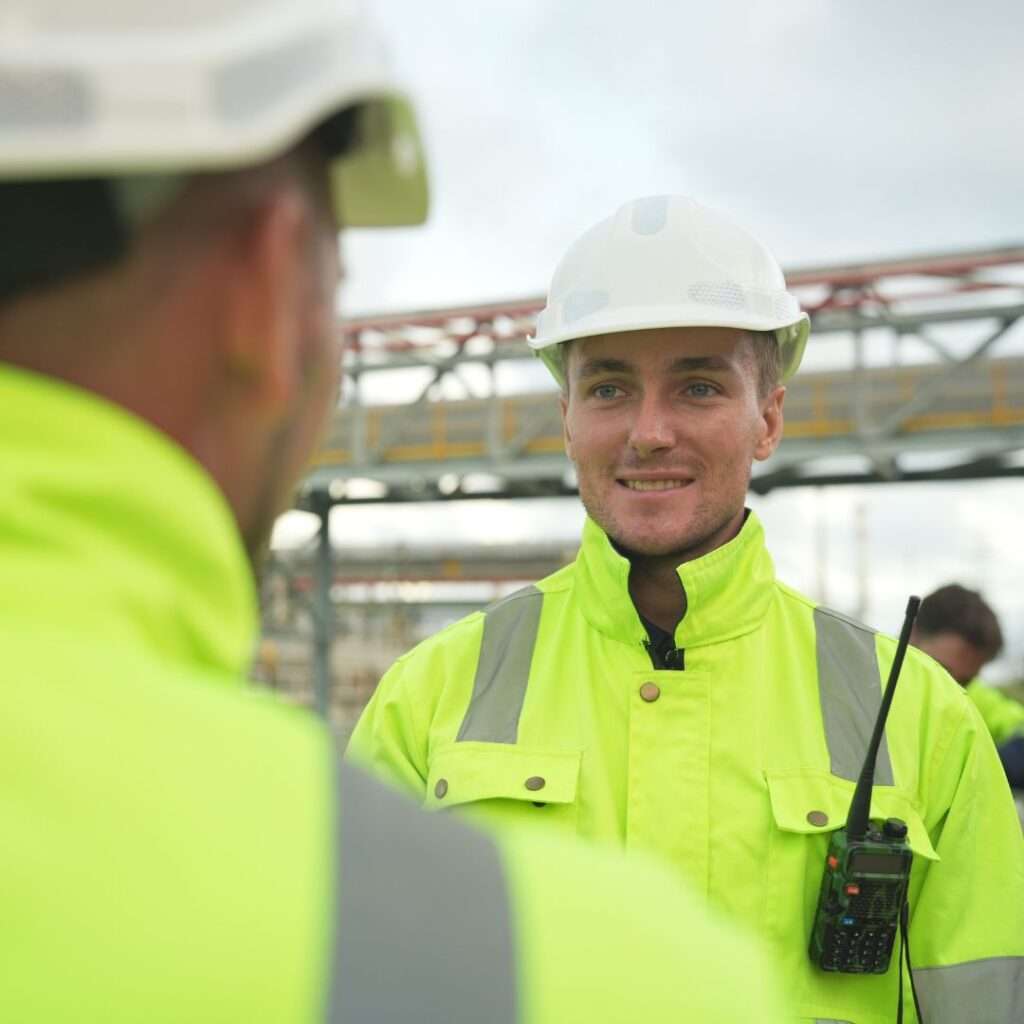 oil and gas workers discussing chemical management systems